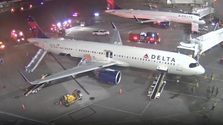 photo showing emergency crews surrounding airplane