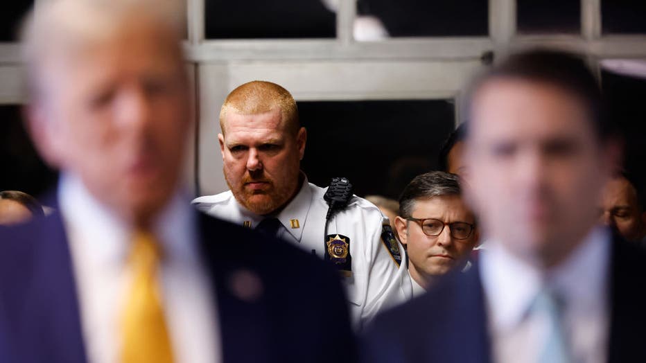 U.S. Speaker of the House Mike Johnson (R-LA) listens as former President Donald Trump speaks to the media as he arrives for his trial for allegedly covering up hush money payments linked to extramarital affairs, at Manhattan Criminal Court on May 14, 2024, in New York City. (Photo by Michael M. Santiago/Getty Images)