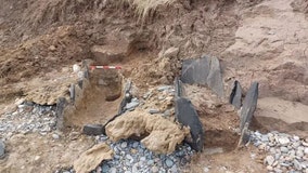 Man walking his dog stumbles across unusual pits on beach, leading to unexpected discovery