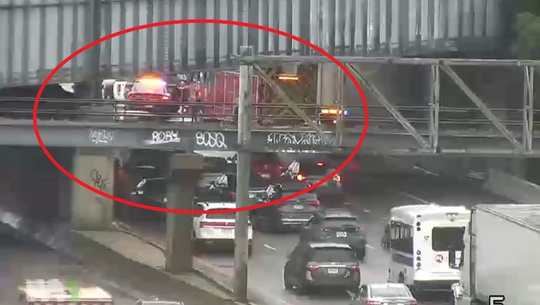 A screenshot from a traffic camera shows police investigating under an overpass near Prior Avenue along I-94 in St. Paul.