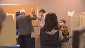 Gus Walz votes for first time, to cheers and a high-five from dad