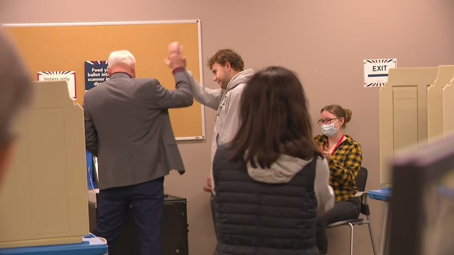 Minnesota Gov. Tim Walz high fives his son, Gus, who voted for the first time