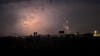 Anoka sky lit up simultaneously by fireworks, lightning