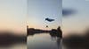 Paraglider strikes power line, crashes into river: Video