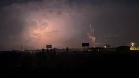 Anoka sky lit up simultaneously by fireworks, lightning