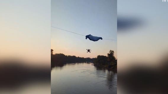 Paraglider strikes power line, crashes into river: Video