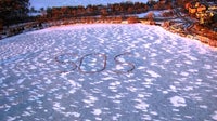 Lake Bde Maka Ska gathering creates 'SOS' message made from people
