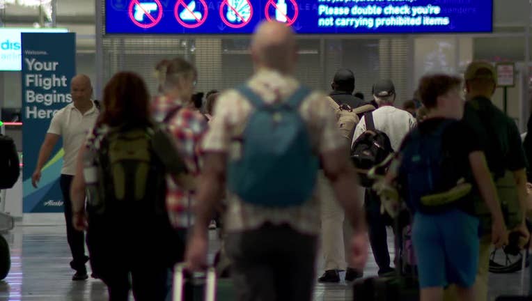 Travelers walking at Minneapolis-St. Paul International Airport.