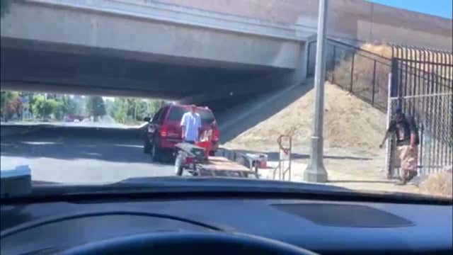 Man arrested after seen on video throwing concrete brick through windshield
