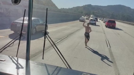 VIDEO: Nearly naked man tries forcing his way onto school bus on 5 Fwy.