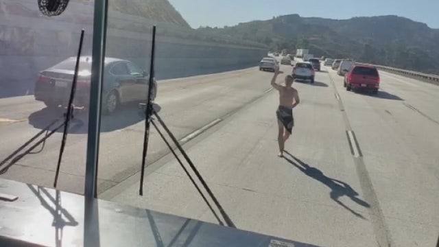 VIDEO: Nearly naked man tries forcing his way onto school bus on 5 Fwy.