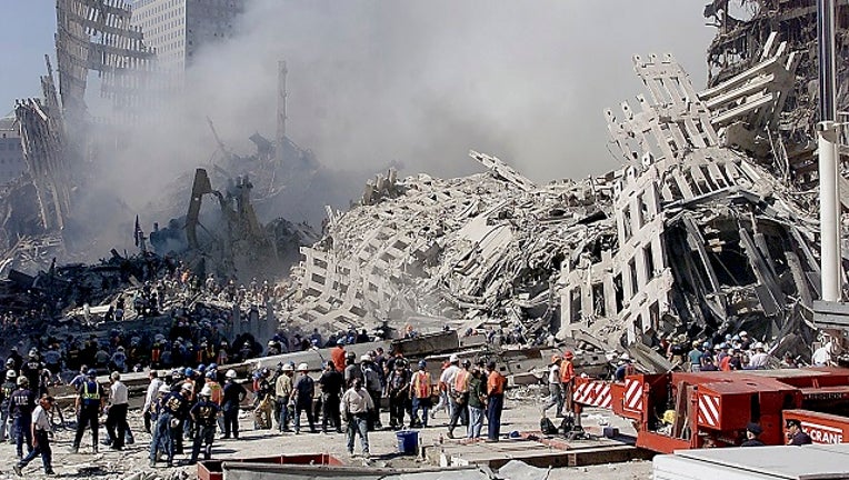 Fire and rescue workers search through the rubble of the World Trade Center 13 September 2001 in New York.