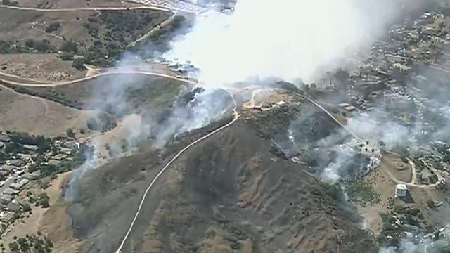 Fire crews work to knock down terrain-driven fire near East L.A.