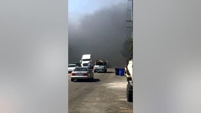 House fire in Fontana sparks blaze in nearby vegetation area