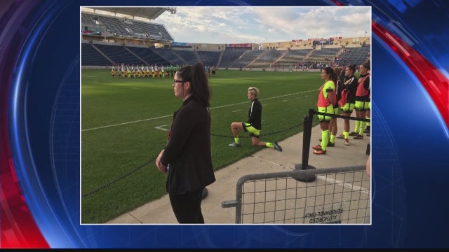 Soccer star Megan Rapinoe kneels during national anthem