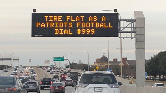 Digital traffic boards mock New England Patriots during Super Bowl week