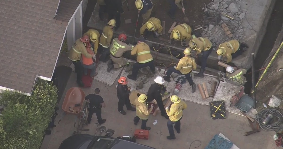 2 workers rescued after becoming trapped in a trench under concrete ...