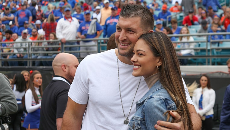 Former Florida Gators quarterback and television analysts Tim Tebow poses for a photo with fiancé Demi-Leigh Nel-Peters during the game between the Georgia Bulldogs and the Florida Gators on November 2, 2019 at TIAA Bank Field in Jacksonville, Fl. (Photo by David Rosenblum/Icon Sportswire via Getty Images)