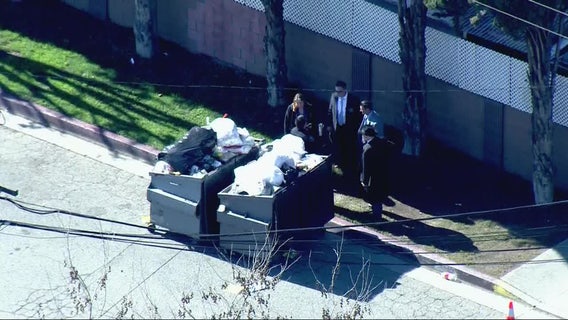 Woman's body found in dumpster, possible suspect detained, police say