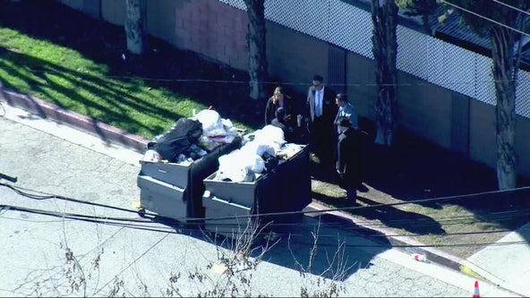 Woman's body found in dumpster, possible suspect detained, police say