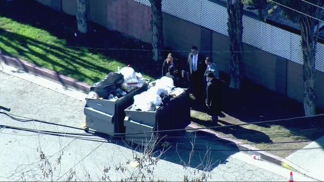 Woman's body found in dumpster, possible suspect detained, police say