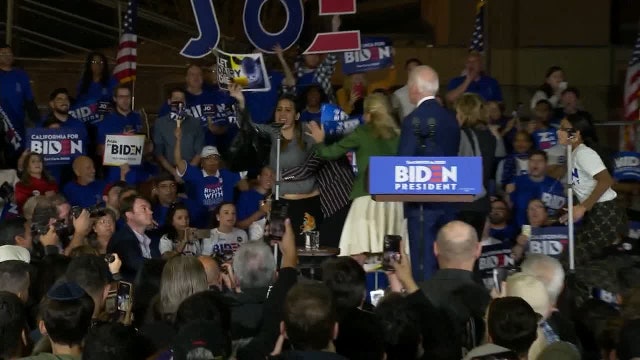 Women holding 'let dairy die' signs storm stage at Biden Super Tuesday event