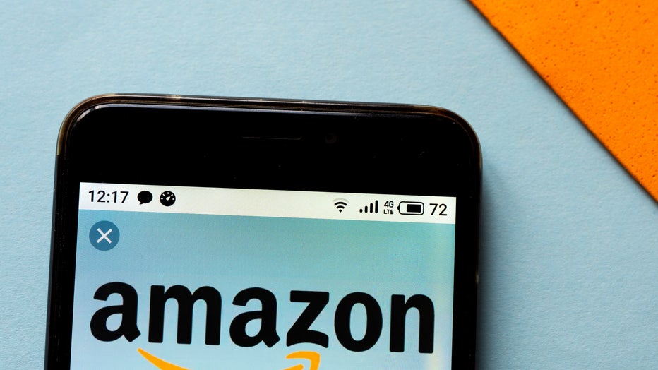 In this photo illustration an Amazon logo seen displayed on