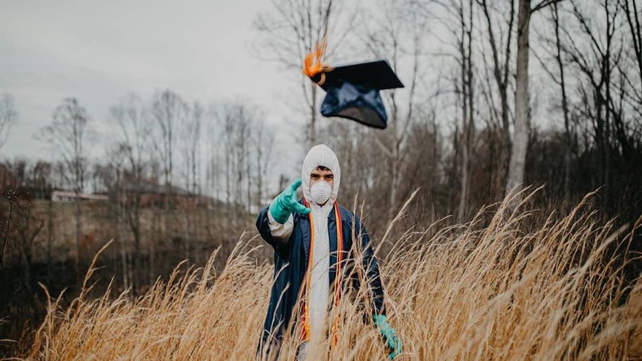 Student dons cap and gown over mask, protective suit in ...