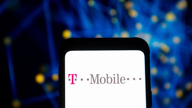 In this photo illustration a T-Mobile logo seen displayed on