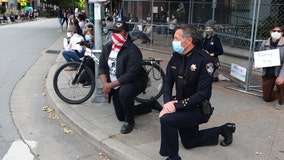 Police officers take a knee for George Floyd, saying his death is disturbing 'to the core'