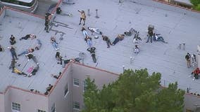 Protesters forming BLM rooftop sign with bodies were invited into complex by residents