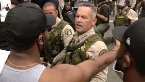 Riverside County Sheriff Chad Bianco and his deputies take a knee in support of protesters