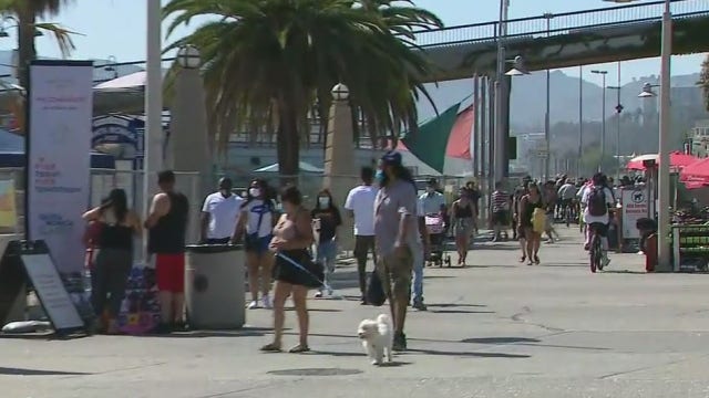 People flock to the beach in the scorching SoCal heat
