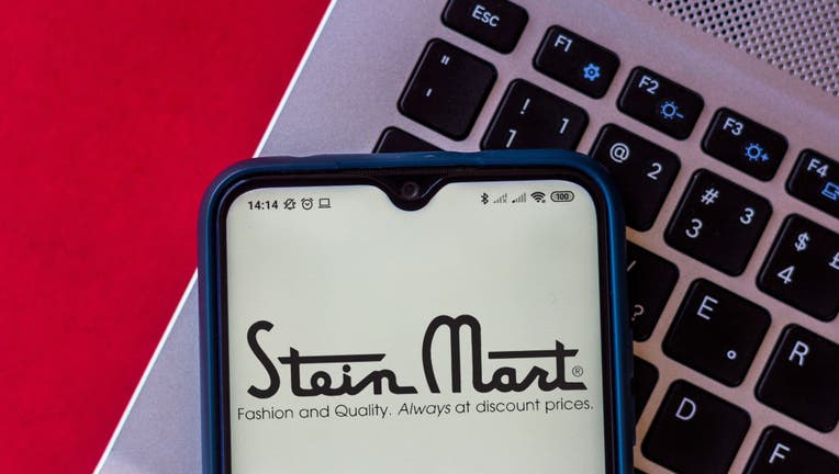In this photo illustration, a Stein Mart logo seen displayed