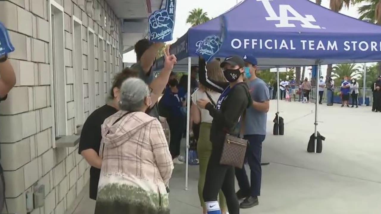 Dodger fans cheering on the Boys in Blue; looking to buy new apparel