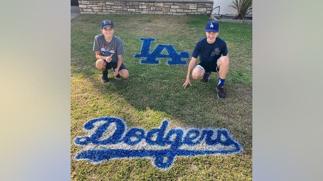 Brothers show their Dodgers spirit spray painting team logos on lawns across Southern California