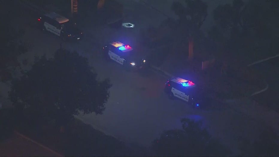 three parked police cars with their red and blue sirens on