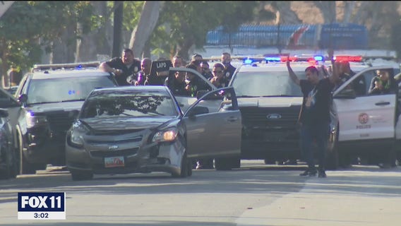 Pursuit suspect, allegedly armed with gun, in custody after brief standoff with LAPD