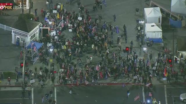 Hundreds gather in Huntington Beach to protest state curfew