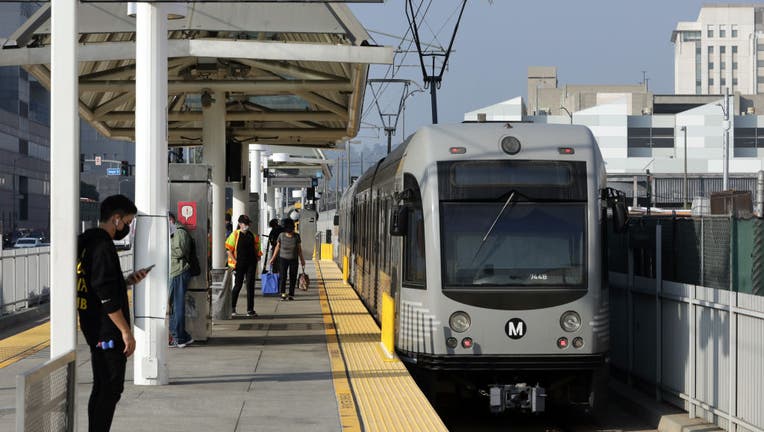 People wait to board the metro train in Los Angeles, California