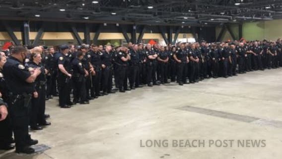 Photo shows dozens of Long Beach police officers standing shoulder-to-shoulder without masks