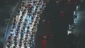 Big rig catches fires, overturns on slick roadway in downtown Los Angeles