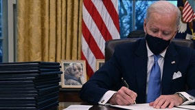 With photo of late son Beau behind him, President Joe Biden begins work at White House