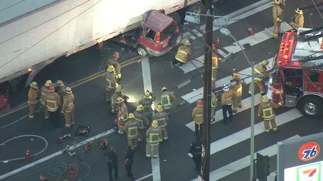 One dead, another injured after car collides into semi-truck in downtown LA