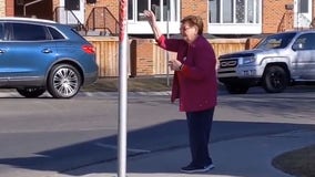Elderly woman spreads love during pandemic by waving every day to strangers on street corner