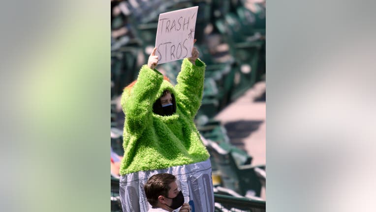 Cheaters!': Astros trashed by fans at Angel Stadium, including one dressed  as Oscar the Grouch