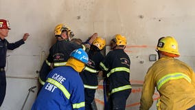 Firefighters free naked woman trapped between two buildings in Santa Ana