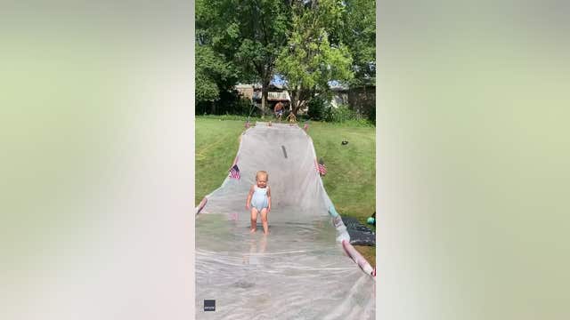 Dad with lightning-fast reflexes catches toddler on slip ‘n slide