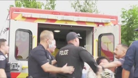 LAPD officer captured on video punching handcuffed suspect after being spit on, witnesses say