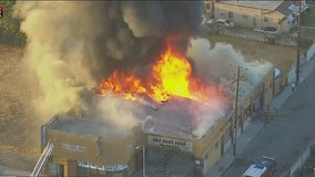 Commercial building fire engulfs auto body shop in Compton